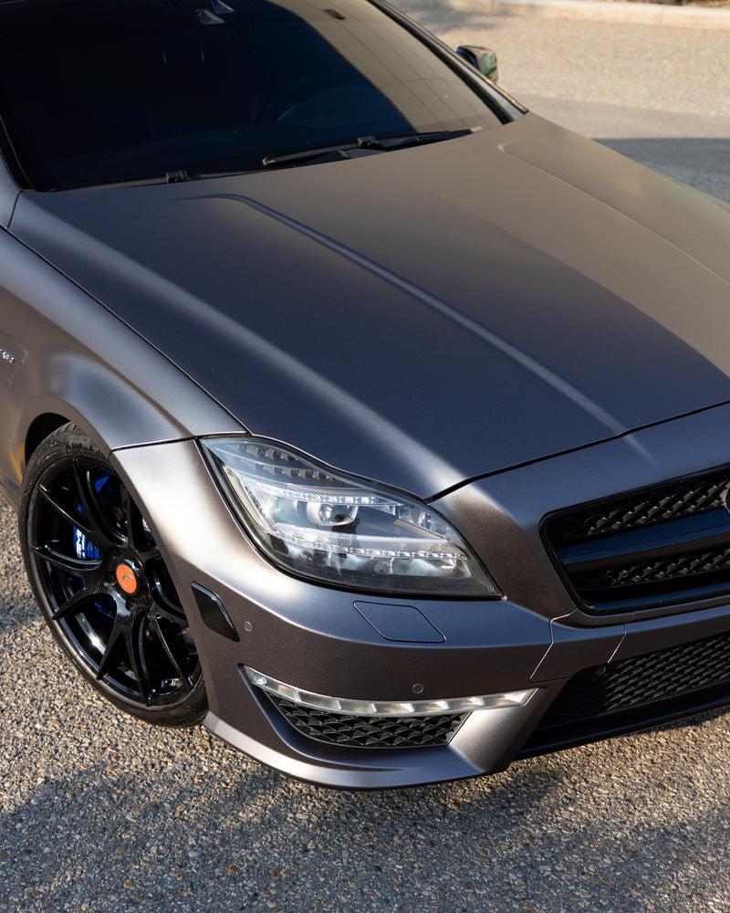 Matte gray Mercedes-Benz with black wheels and aggressive front styling featuring premium vehicle wrap and paint protection film installed by wraptors calgary