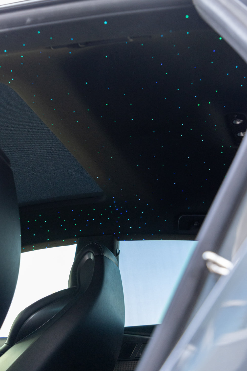 Car interior with a starlight headliner ceiling installed by wraptors calgary