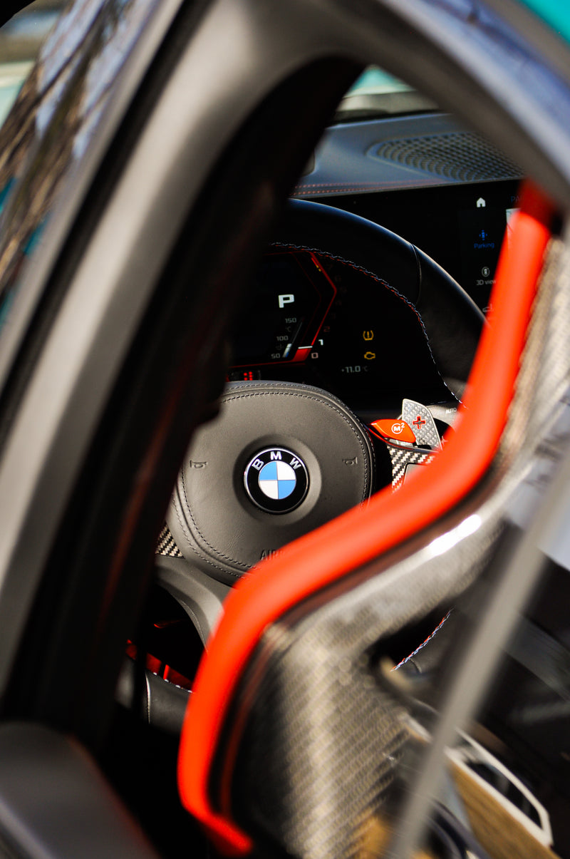 Interior steering wheel detail BMW M3 Competition performance build Calgary, part of full vehicle wrap and customization project